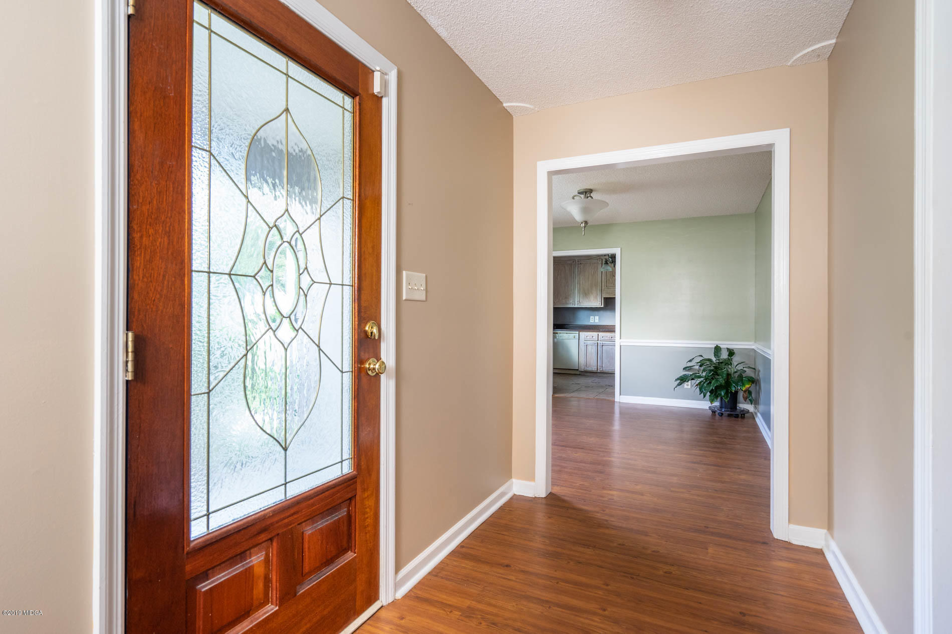 123 Timber Ridge Drive Macon, GA 31216 - Photo 3 of 26 hallway with wooden floor and windows