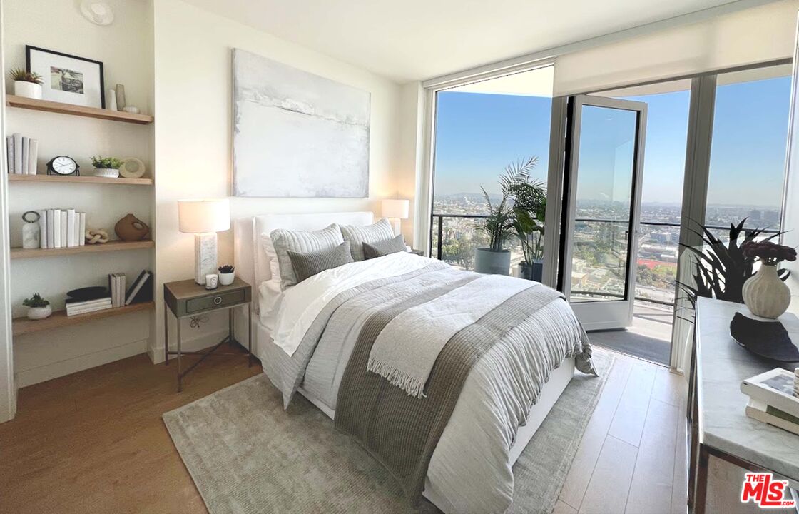 11750 Wilshire Boulevard, Unit 2404 Los Angeles, CA 90025 - Photo 2 of 38 a spacious bedroom with a bed and a couch