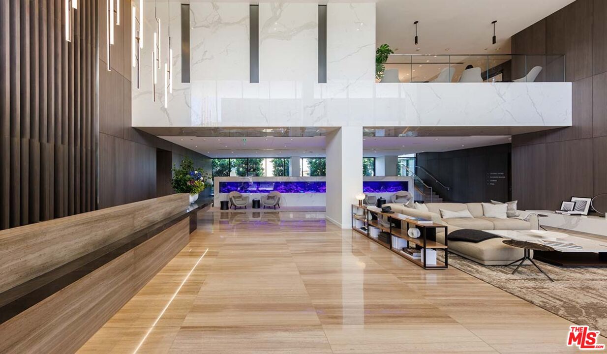 11750 Wilshire Boulevard, Unit 2404 Los Angeles, CA 90025 - Photo 23 of 38 a view of a patio with dining table and chairs under an umbrella with a barbeque grill