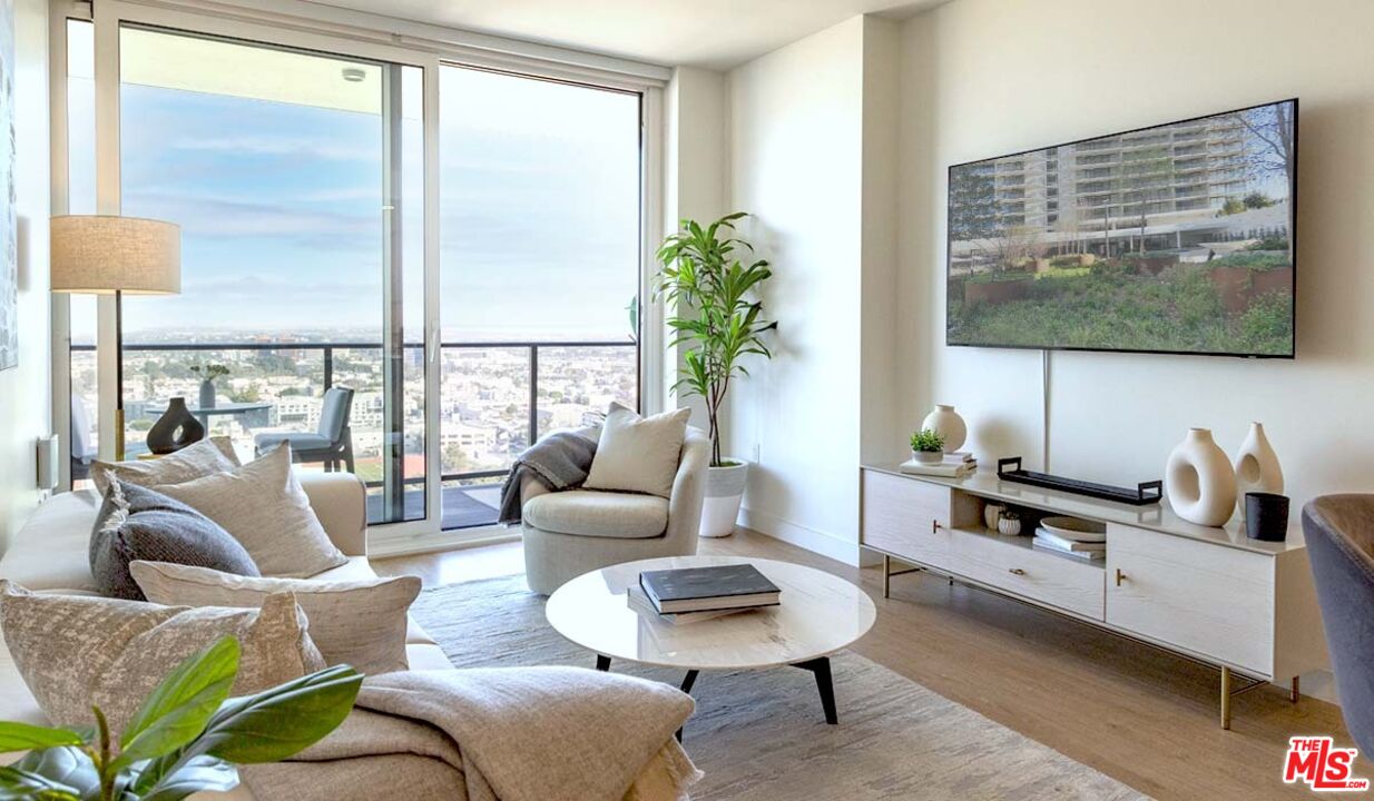 11750 Wilshire Boulevard, Unit 2404 Los Angeles, CA 90025 - Photo 3 of 38 a living room with furniture and a flat screen tv