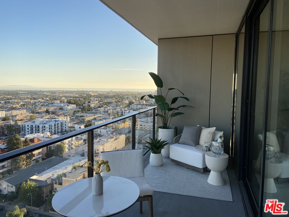 11750 Wilshire Boulevard, Unit 2404 Los Angeles, CA 90025 - Photo 4 of 38 a balcony with furniture and a potted plant