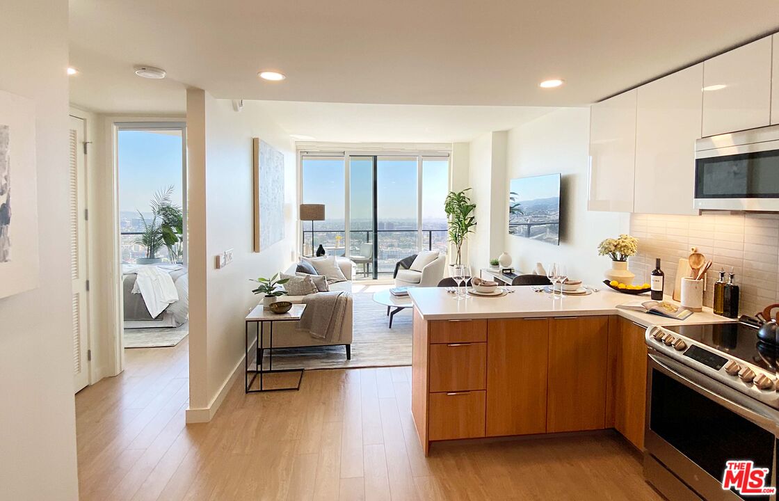 11750 Wilshire Boulevard, Unit 2404 Los Angeles, CA 90025 - Photo 5 of 38 a open kitchen with sink cabinets and wooden floor