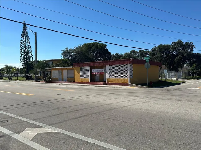a view of a yard with table and chairs a fire pit and a large tree