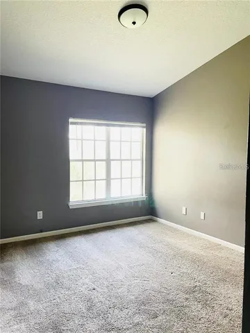 an empty room with a empty space and windows