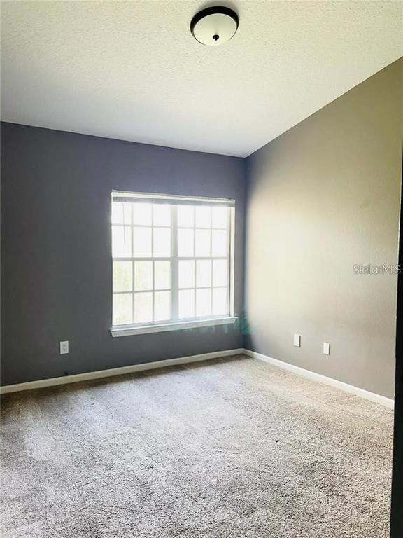 4348 South Kirkman Road, Unit 806 Orlando, FL 32811 - Photo 11 of 29 an empty room with a empty space and windows