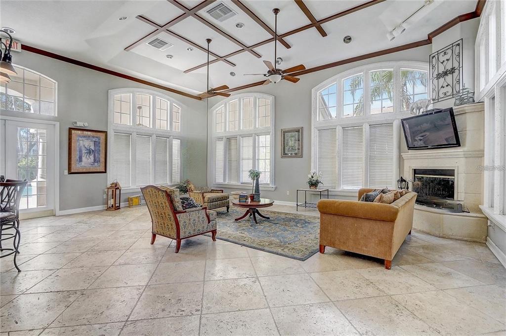 4348 South Kirkman Road, Unit 806 Orlando, FL 32811 - Photo 16 of 29 a living room with furniture a fireplace and a flat screen tv