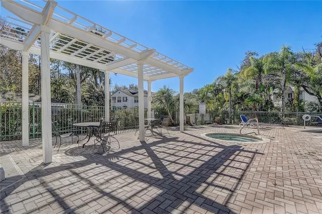 a view of a patio with a table and chairs under an umbrella
