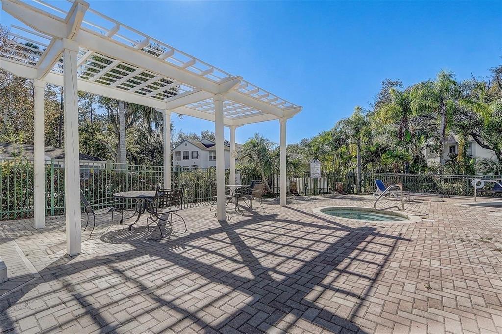 4348 South Kirkman Road, Unit 806 Orlando, FL 32811 - Photo 23 of 29 a view of a patio with a table and chairs under an umbrella