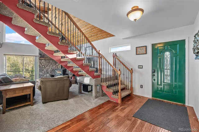 a view of entryway and hall with wooden floor
