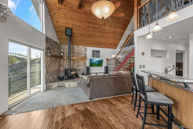 a kitchen with furniture and a wooden floor