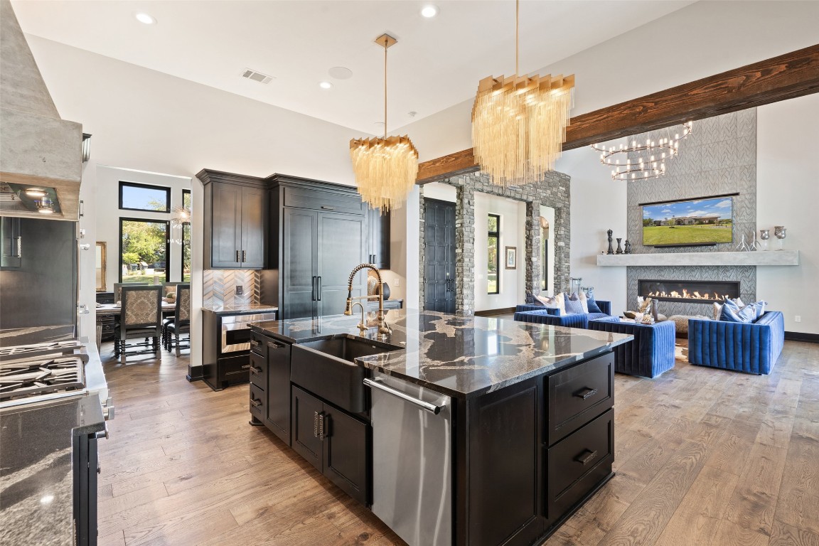 19204 Secretariat Place Spicewood, TX 78669 - Photo 13 of 40 a kitchen with stainless steel appliances a stove center island and a refrigerator