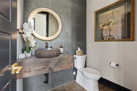 a bathroom with a toilet a sink and a mirror