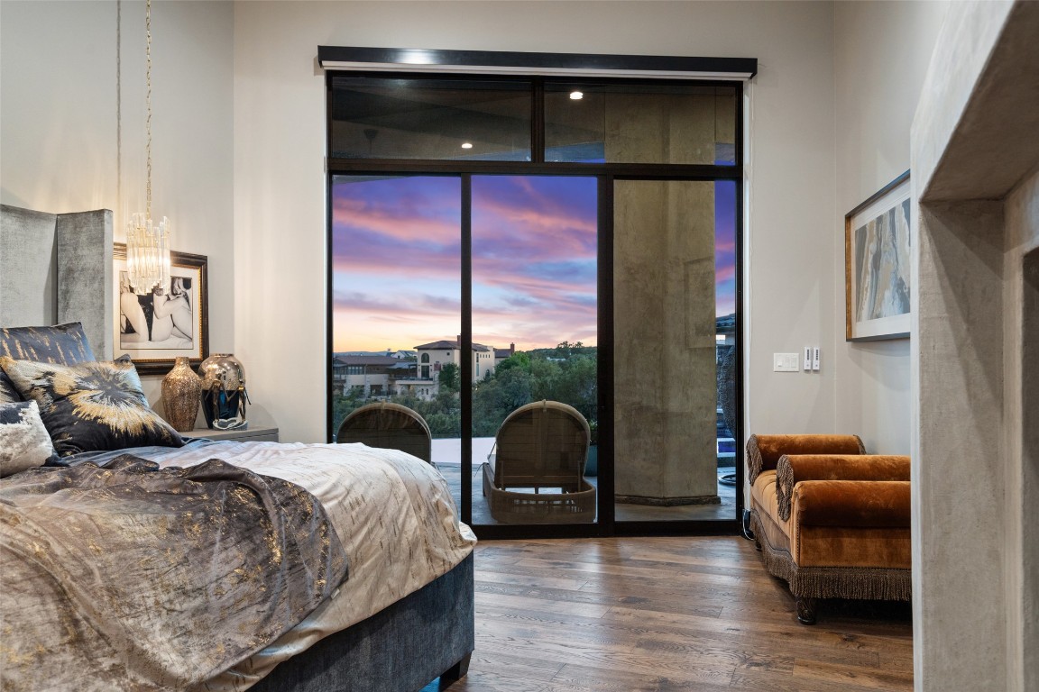 19204 Secretariat Place Spicewood, TX 78669 - Photo 25 of 40 a bedroom with furniture and large windows