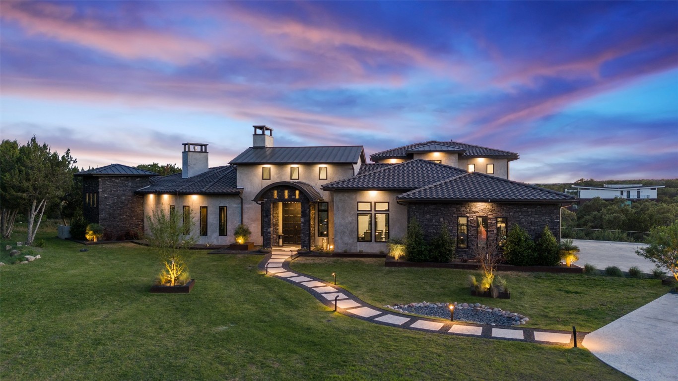19204 Secretariat Place Spicewood, TX 78669 - Photo 37 of 40 a front view of a house with a garden