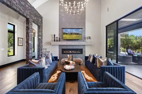 a living room with furniture fireplace and a large window