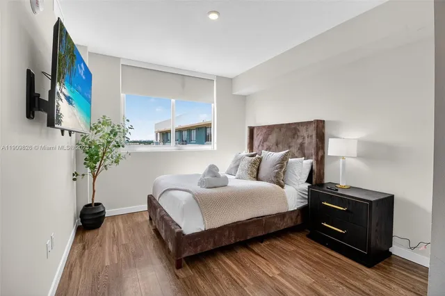 a bedroom with a bed and a potted plant