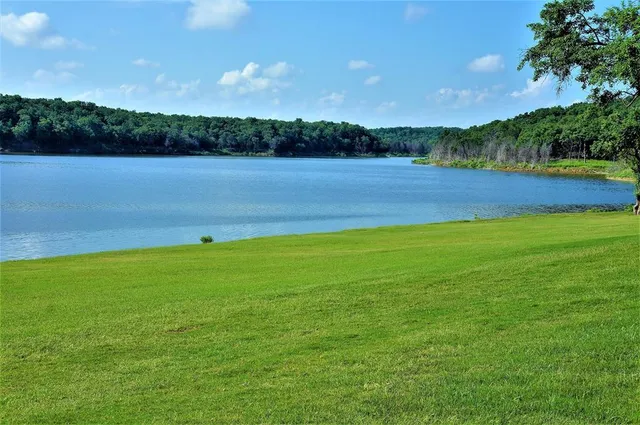 a view of a lake with houses in the back