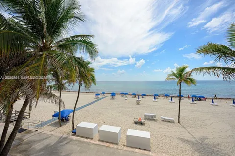 a view of beach with palm trees