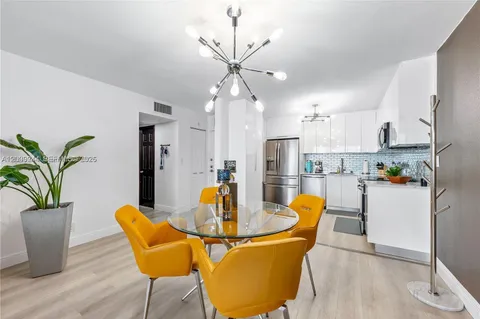 a dining room filled counter top space a refrigerator and kitchen view