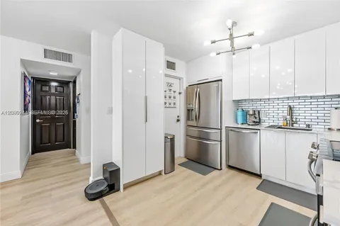 a kitchen with stainless steel appliances a refrigerator and cabinets