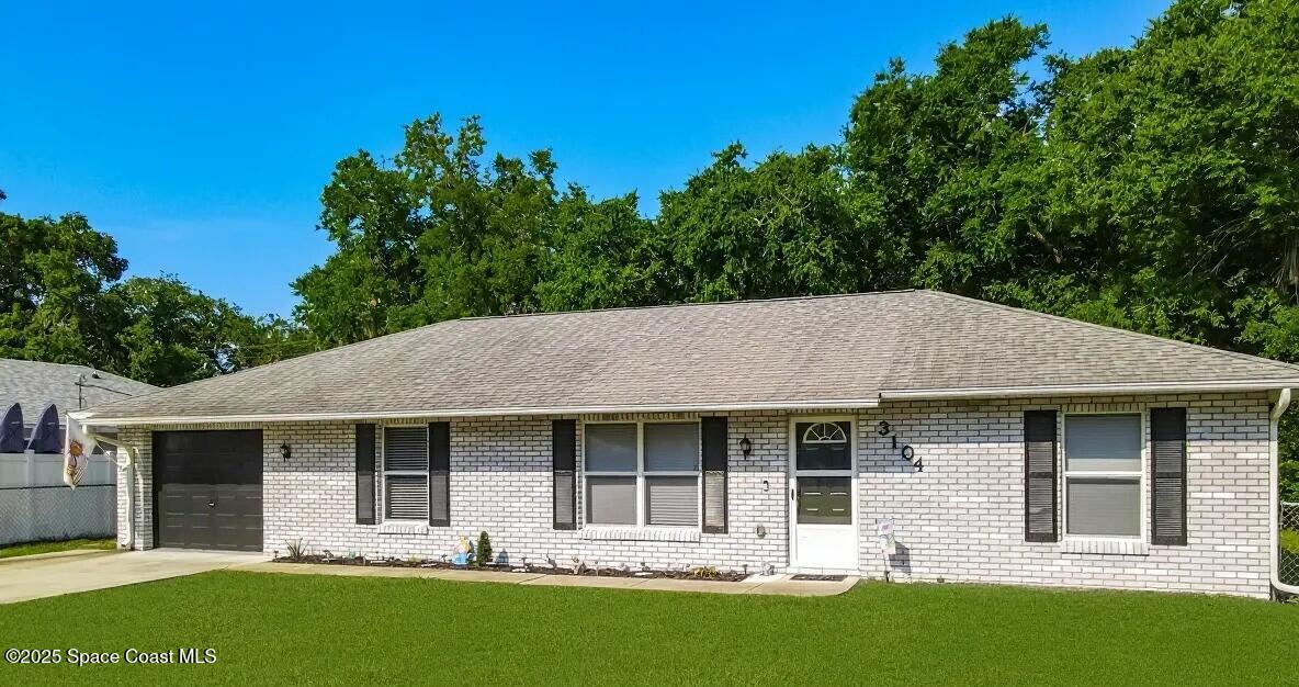 3104 Lime Tree Drive Edgewater, FL 32141 - Photo 1 of 32 a view of a house with a yard and plants