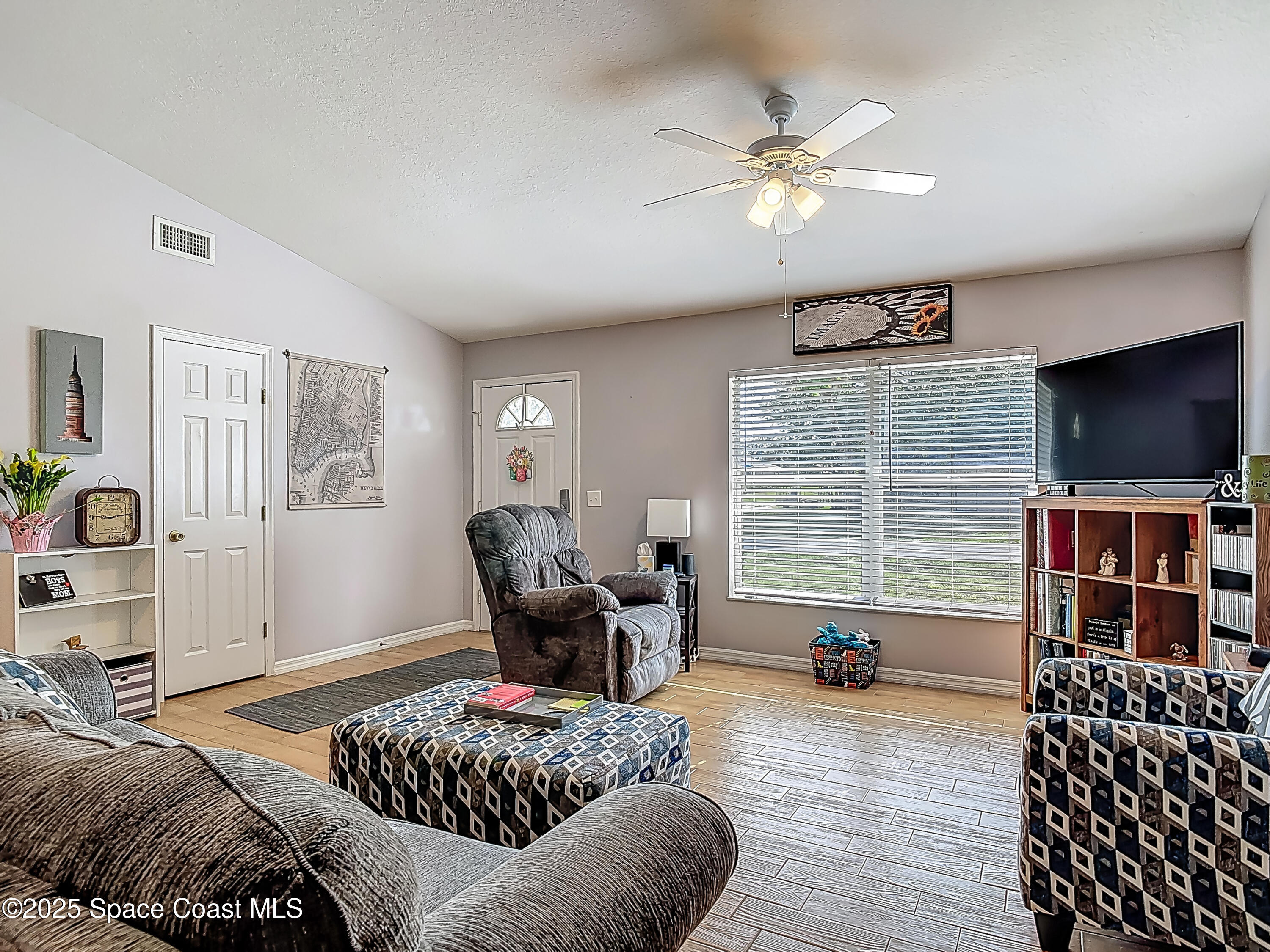 3104 Lime Tree Drive Edgewater, FL 32141 - Photo 13 of 32 a living room with furniture and a flat screen tv