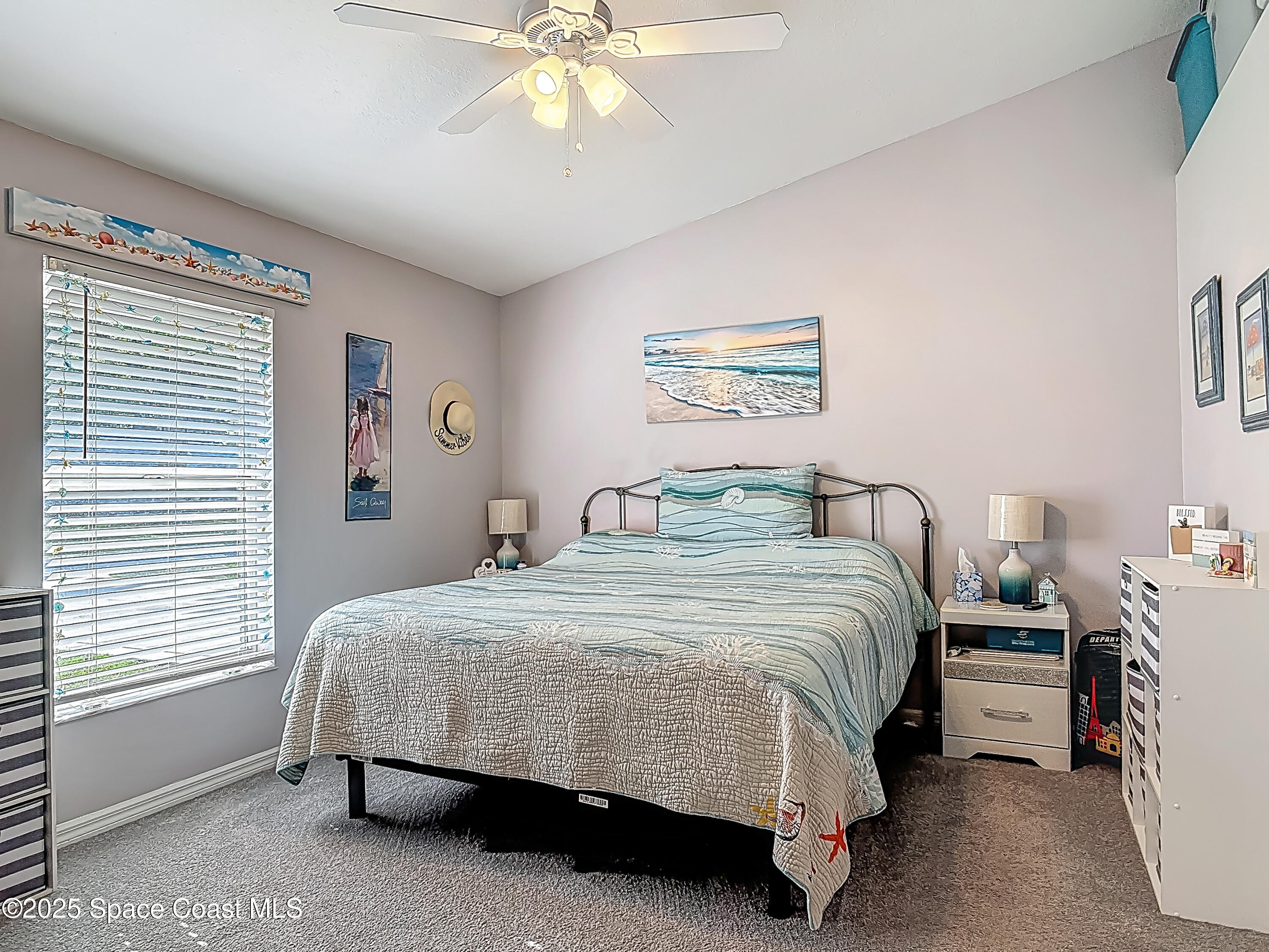 3104 Lime Tree Drive Edgewater, FL 32141 - Photo 14 of 32 a bedroom with a bed and a chandelier