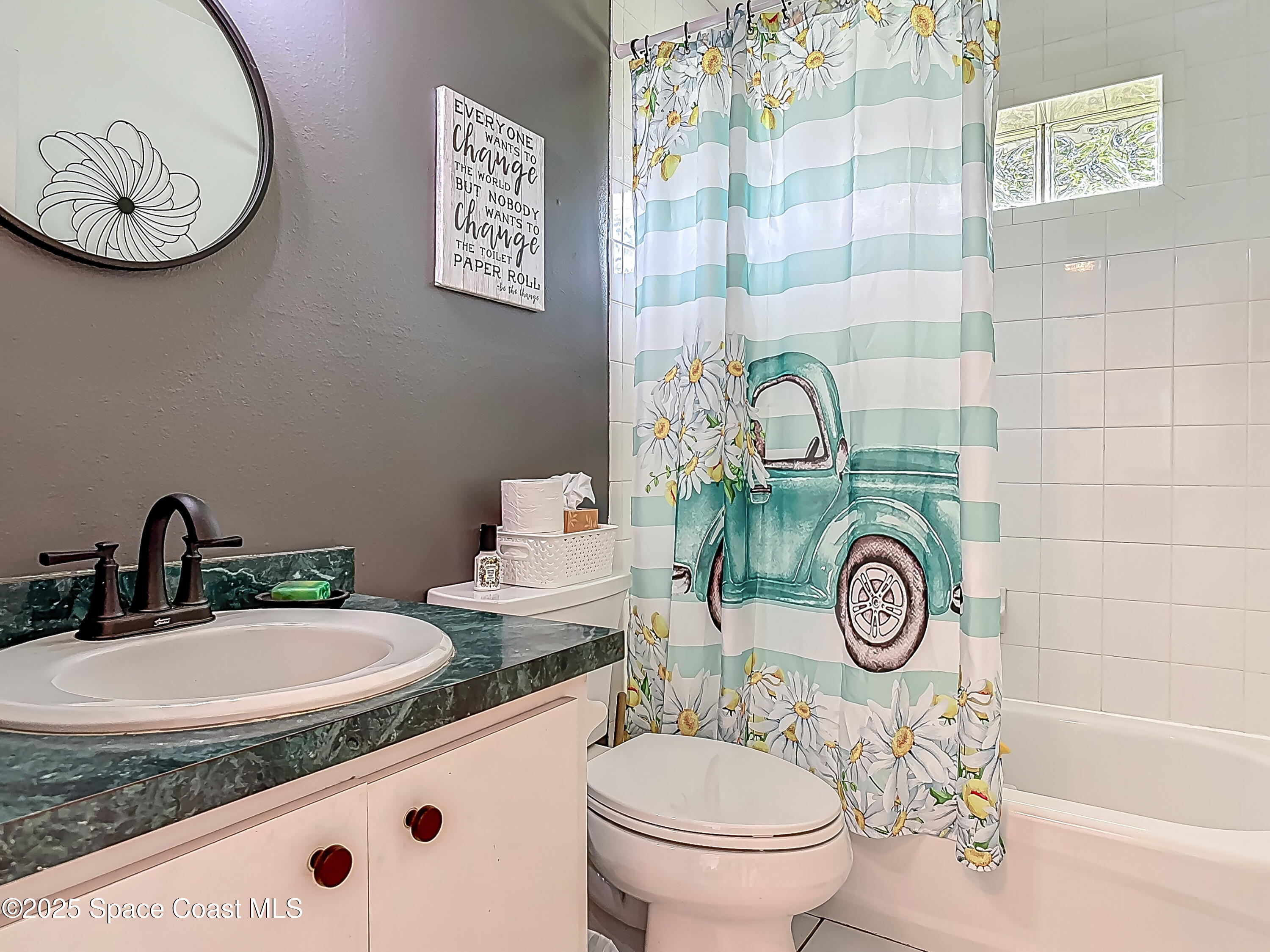 3104 Lime Tree Drive Edgewater, FL 32141 - Photo 20 of 32 a bathroom with a toilet sink and mirror