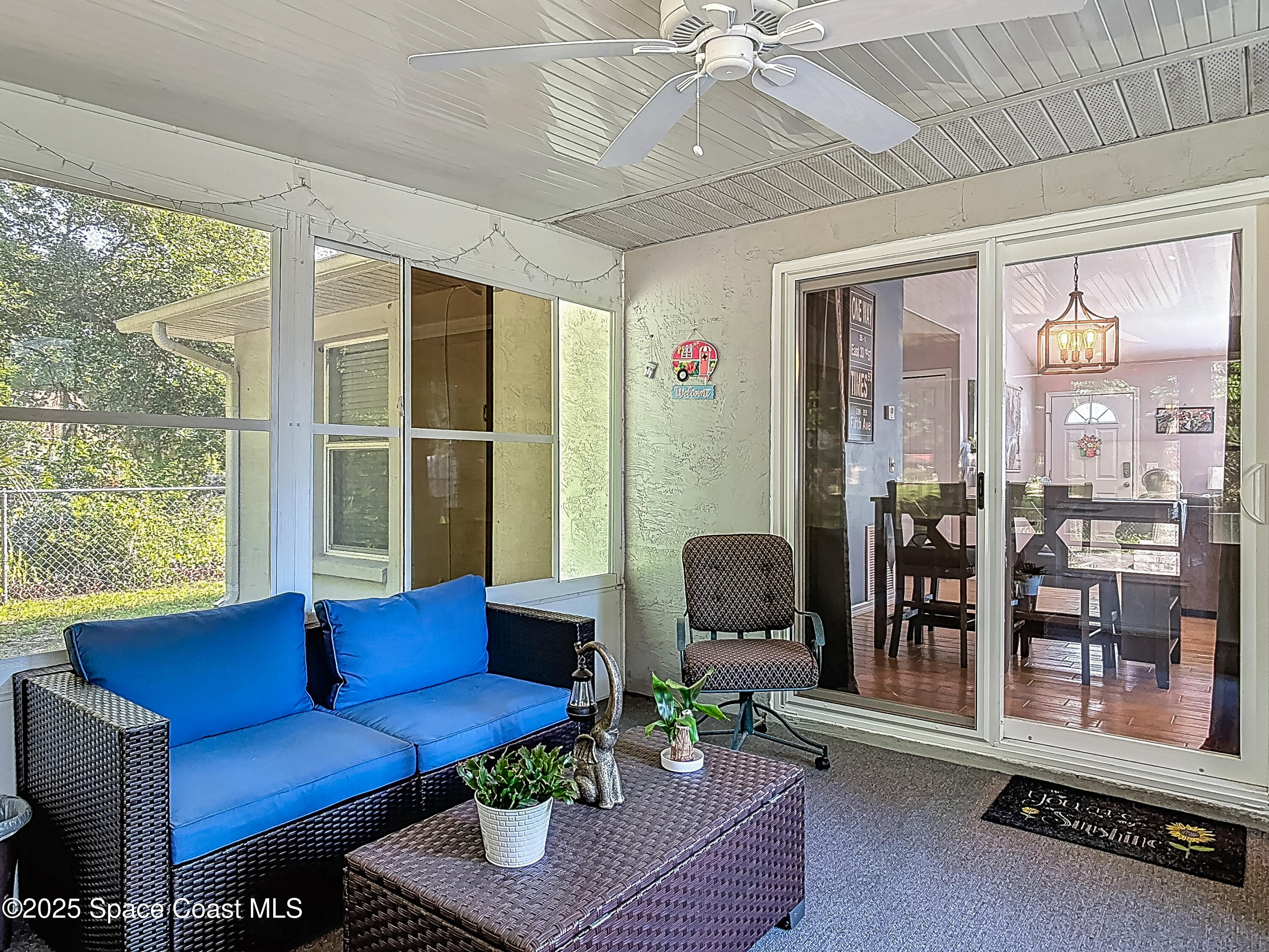 3104 Lime Tree Drive Edgewater, FL 32141 - Photo 21 of 32 a living room with furniture and a floor to ceiling window