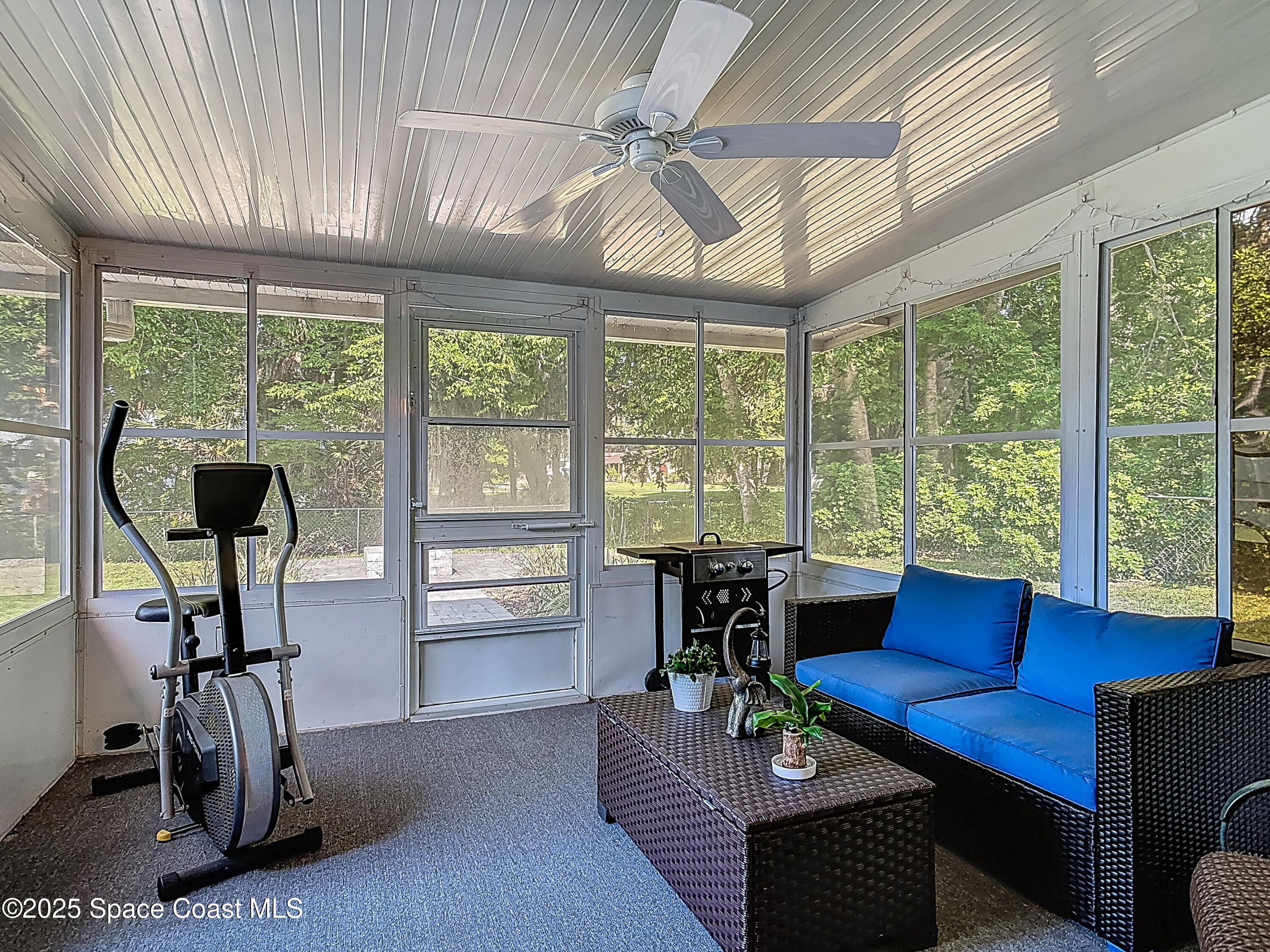 3104 Lime Tree Drive Edgewater, FL 32141 - Photo 22 of 32 a living room with furniture a ceiling fan and a large window