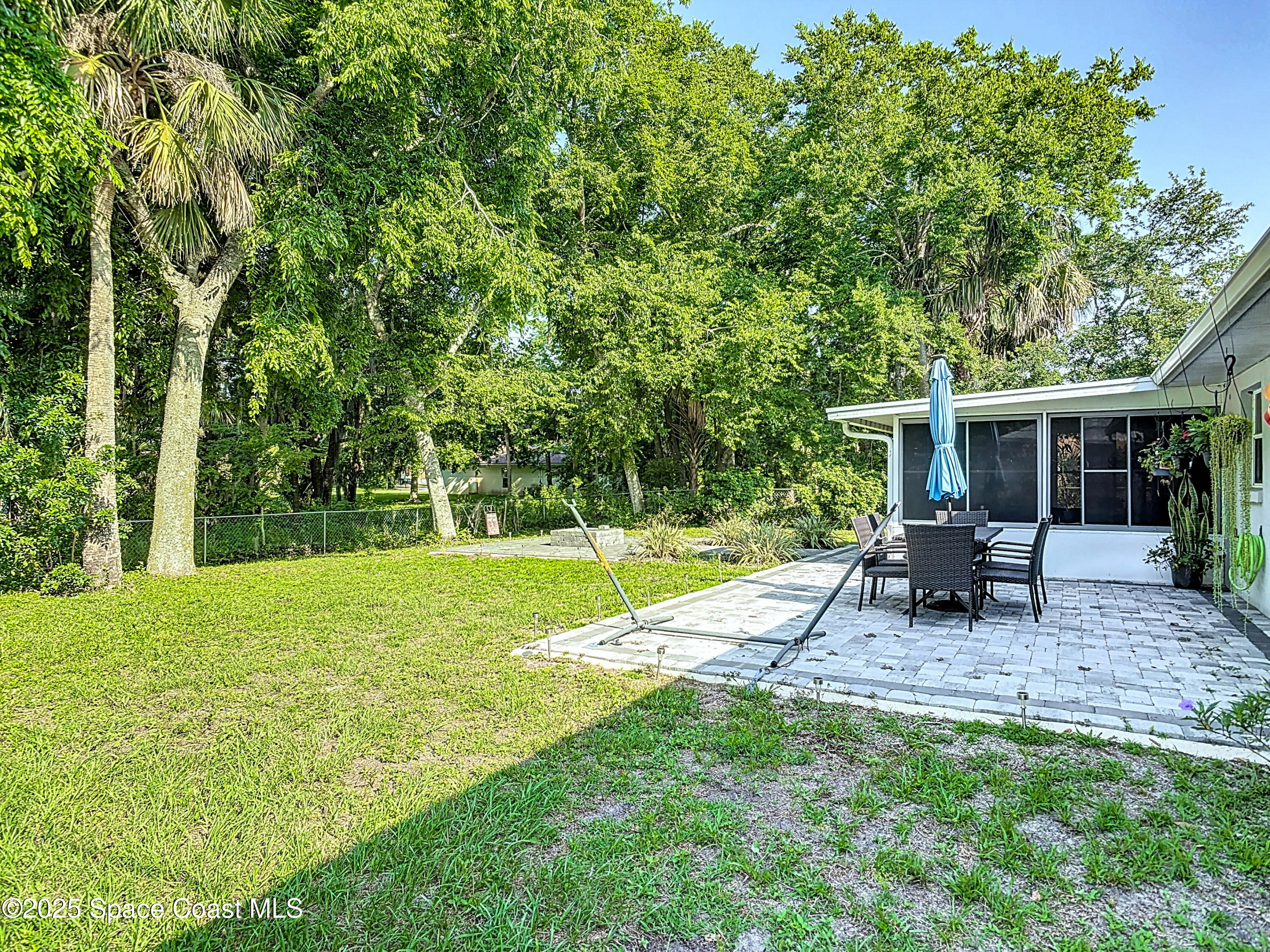 3104 Lime Tree Drive Edgewater, FL 32141 - Photo 26 of 32 a backyard of a house with table and chairs