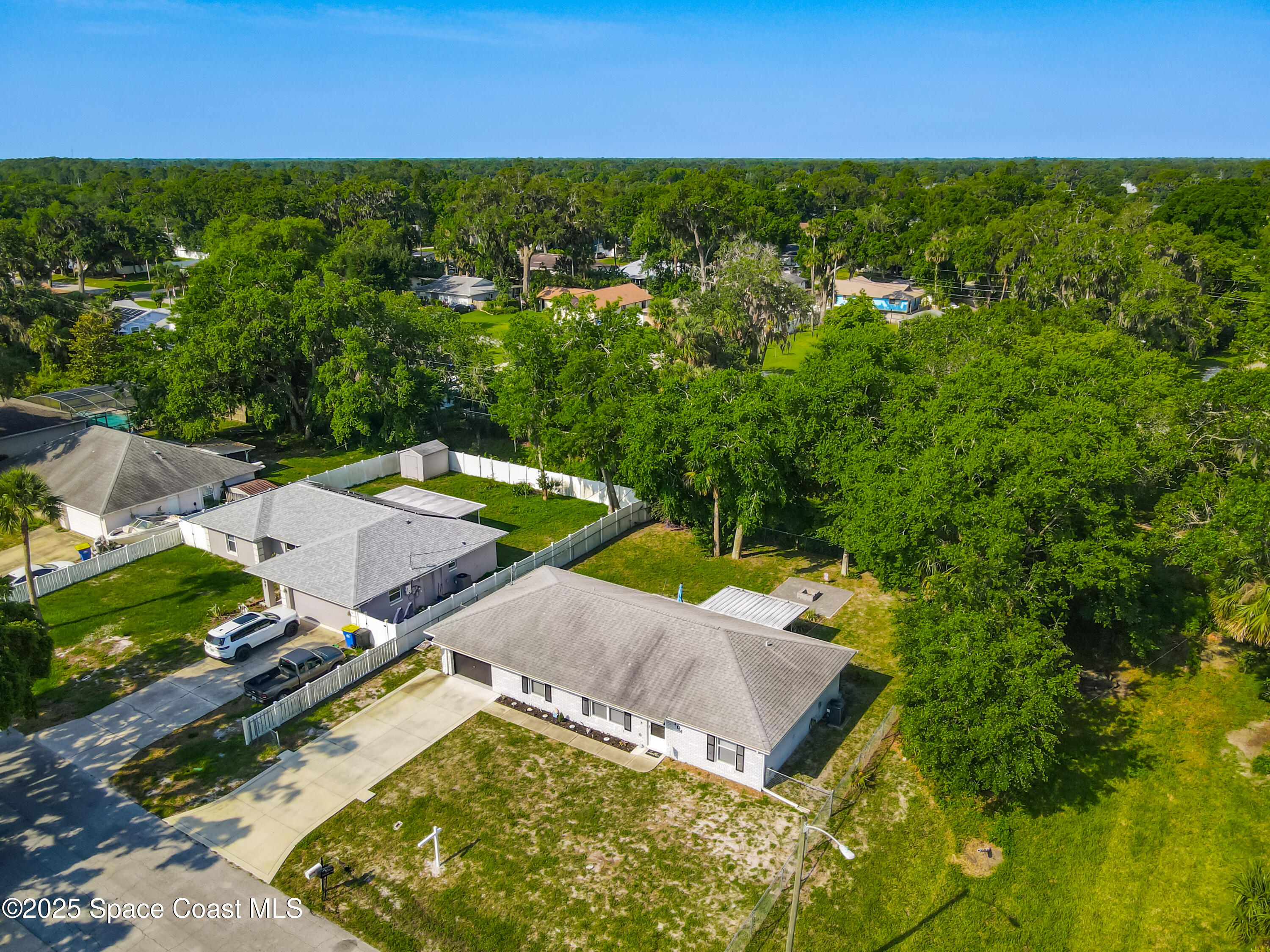 3104 Lime Tree Drive Edgewater, FL 32141 - Photo 28 of 32 an aerial view of residential houses with outdoor space and trees