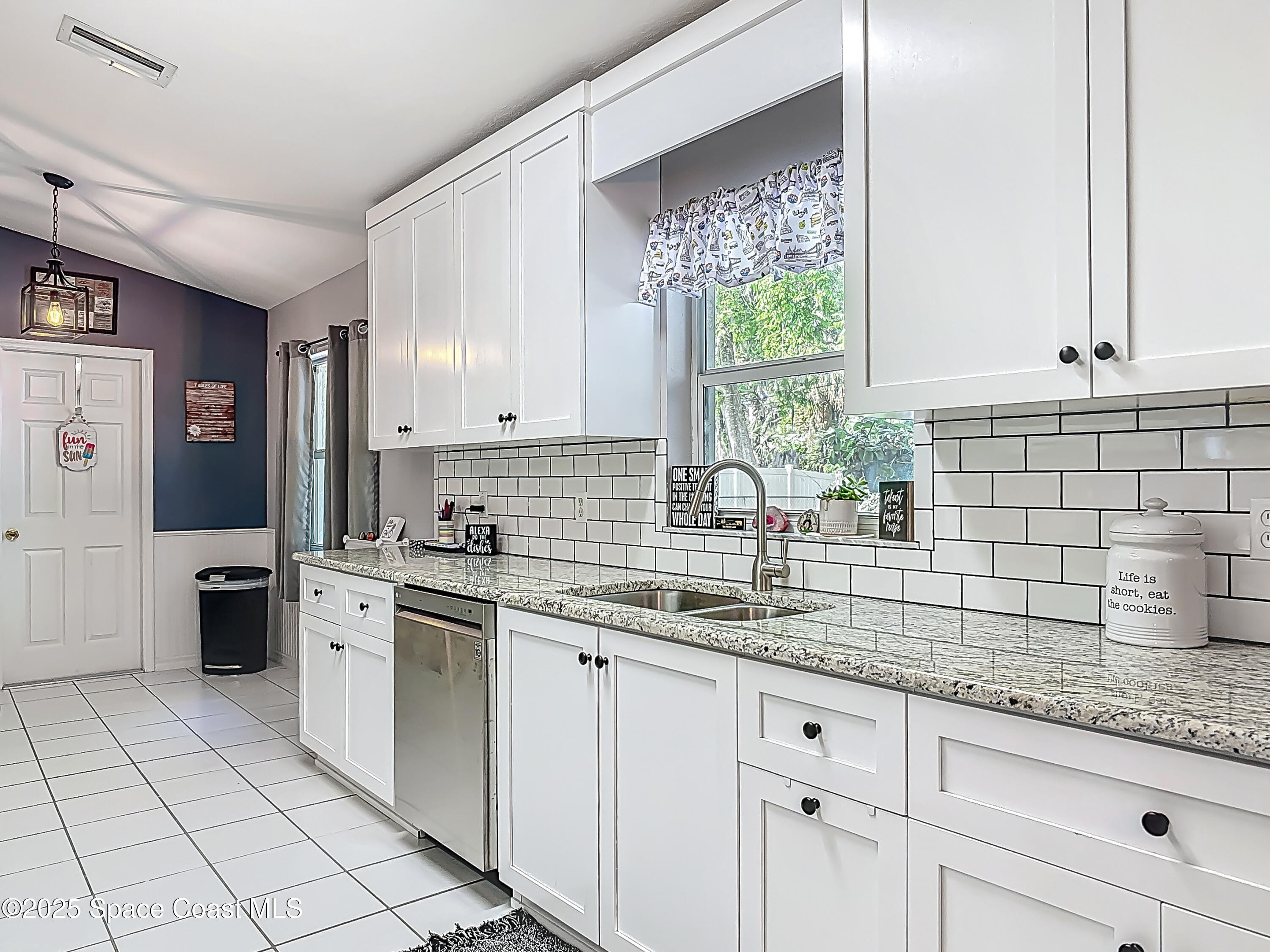3104 Lime Tree Drive Edgewater, FL 32141 - Photo 3 of 32 a kitchen with stainless steel appliances granite countertop a sink and cabinets