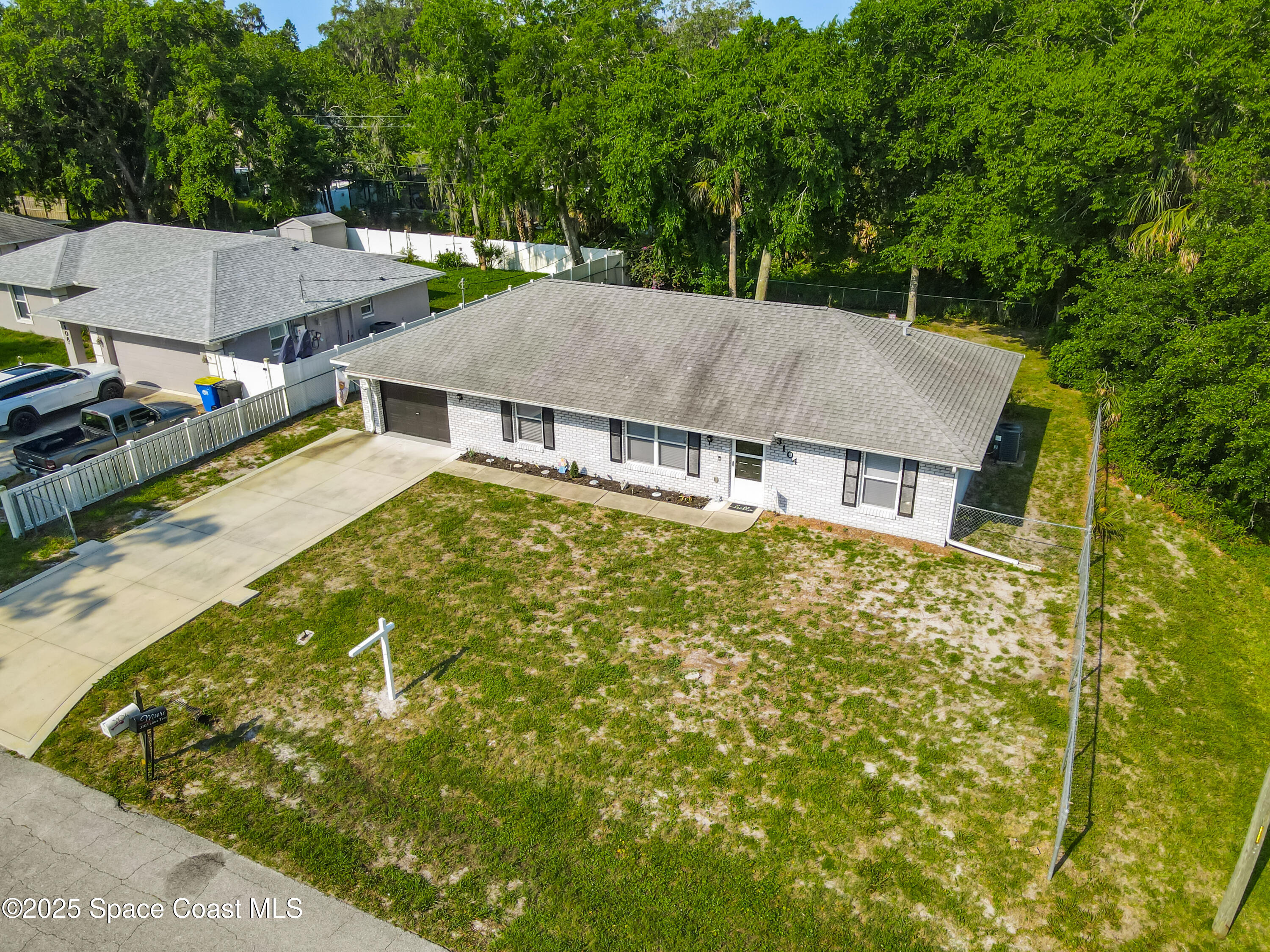 3104 Lime Tree Drive Edgewater, FL 32141 - Photo 32 of 32 an aerial view of a house with swimming pool and large trees
