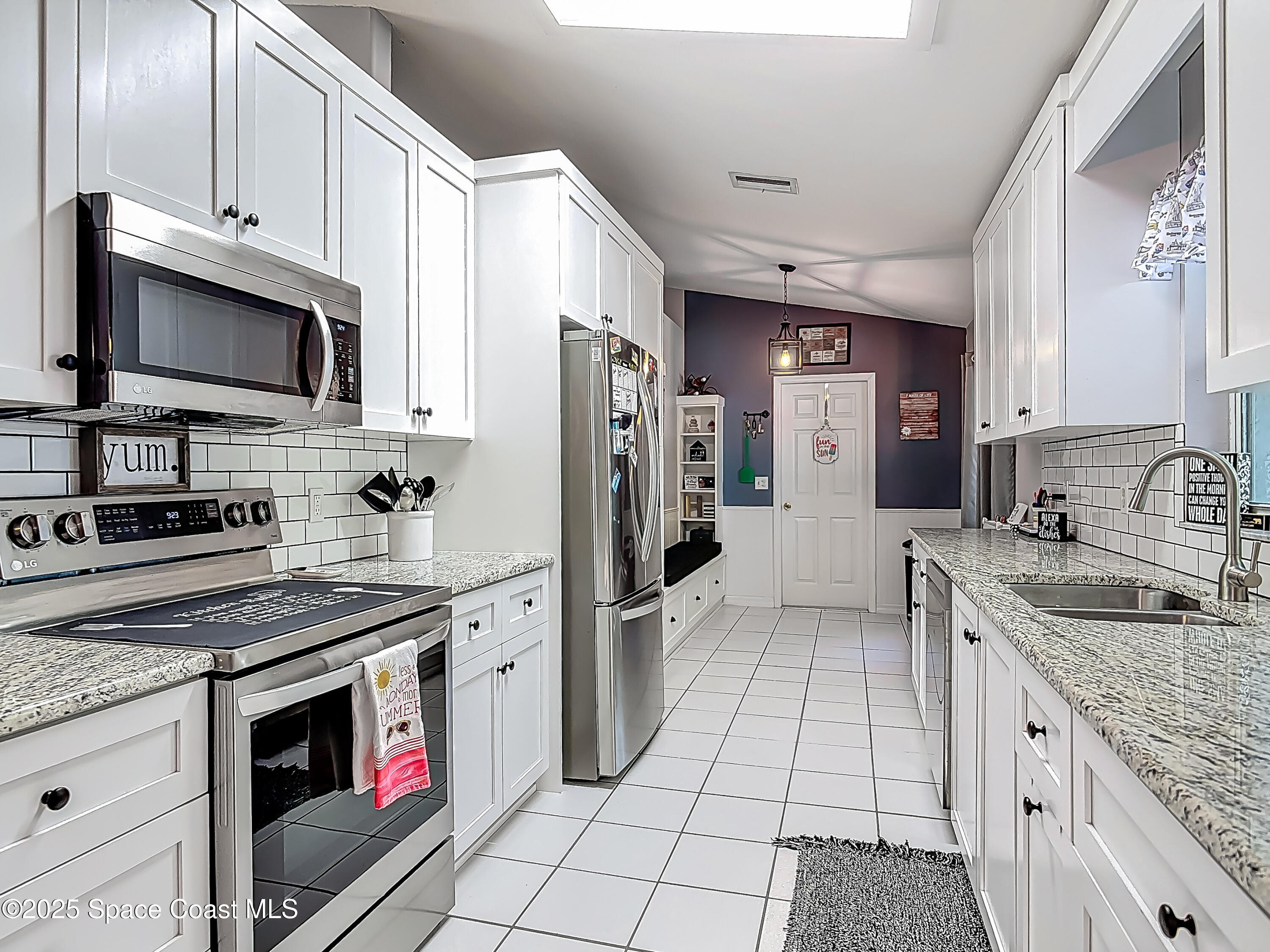 3104 Lime Tree Drive Edgewater, FL 32141 - Photo 4 of 32 a kitchen with stainless steel appliances granite countertop a sink stove refrigerator and cabinets