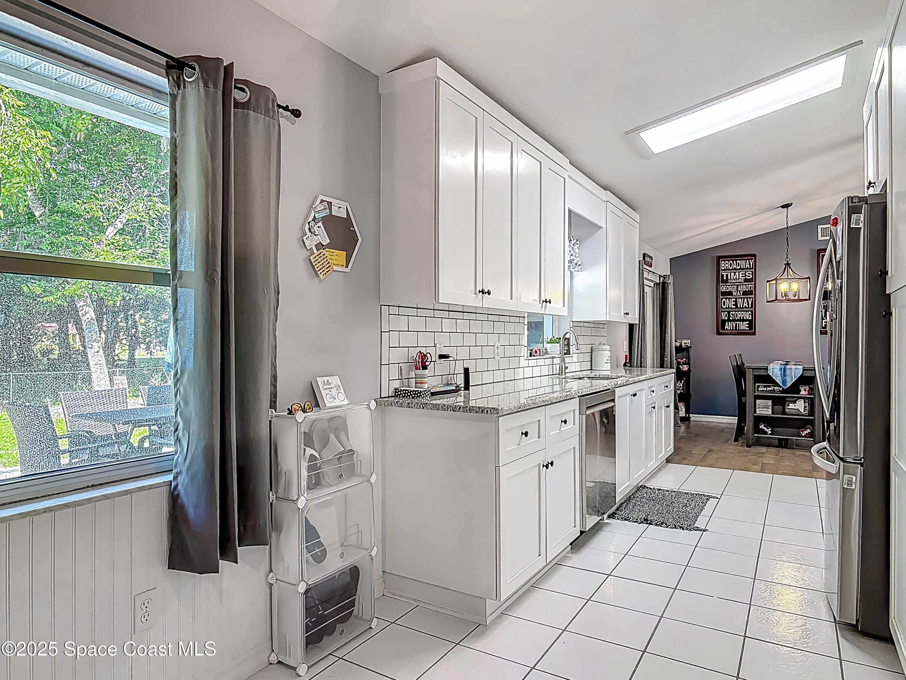 3104 Lime Tree Drive Edgewater, FL 32141 - Photo 6 of 32 a kitchen with a sink window and cabinets