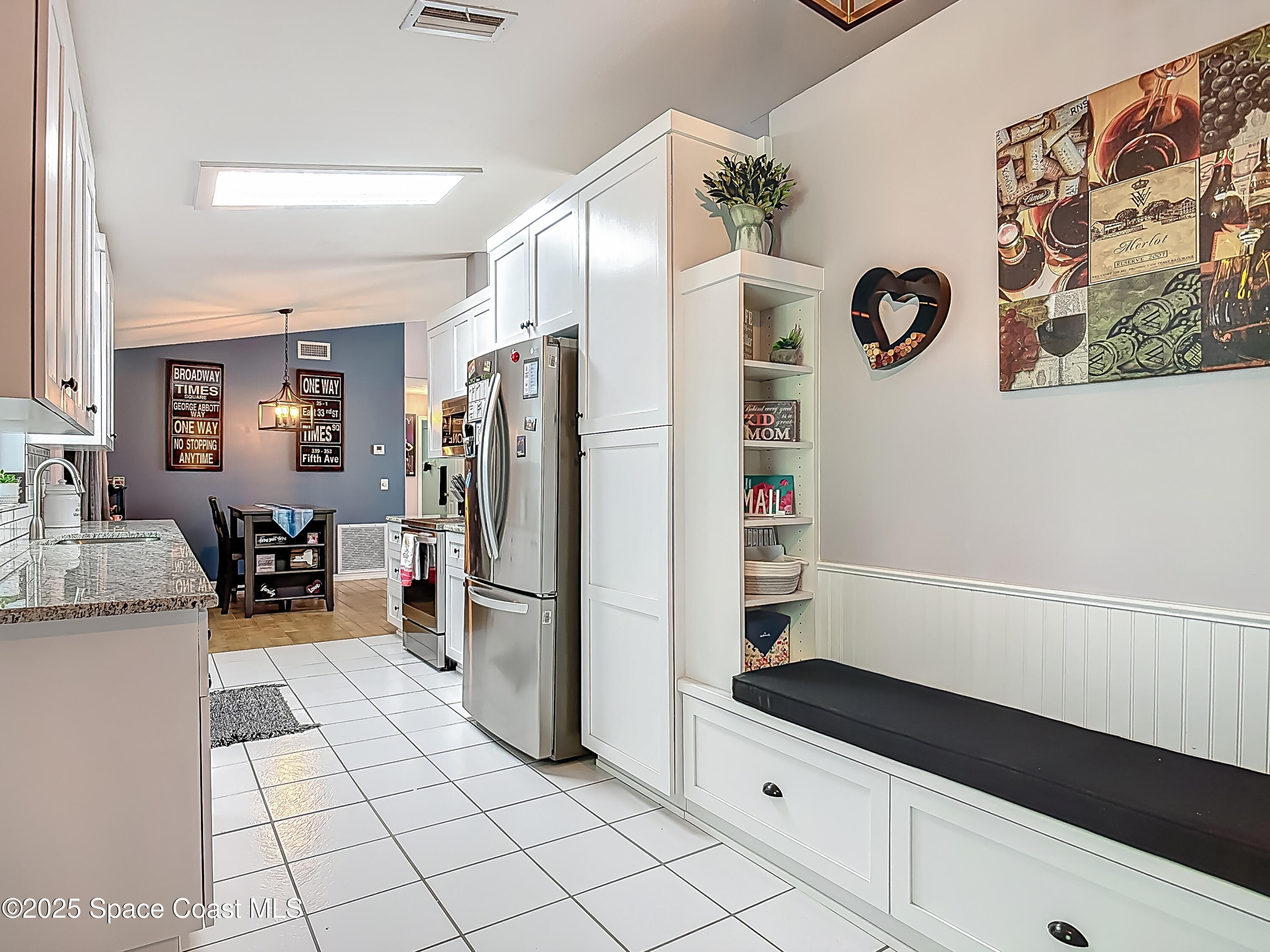 3104 Lime Tree Drive Edgewater, FL 32141 - Photo 8 of 32 a kitchen with a refrigerator and a stove top oven
