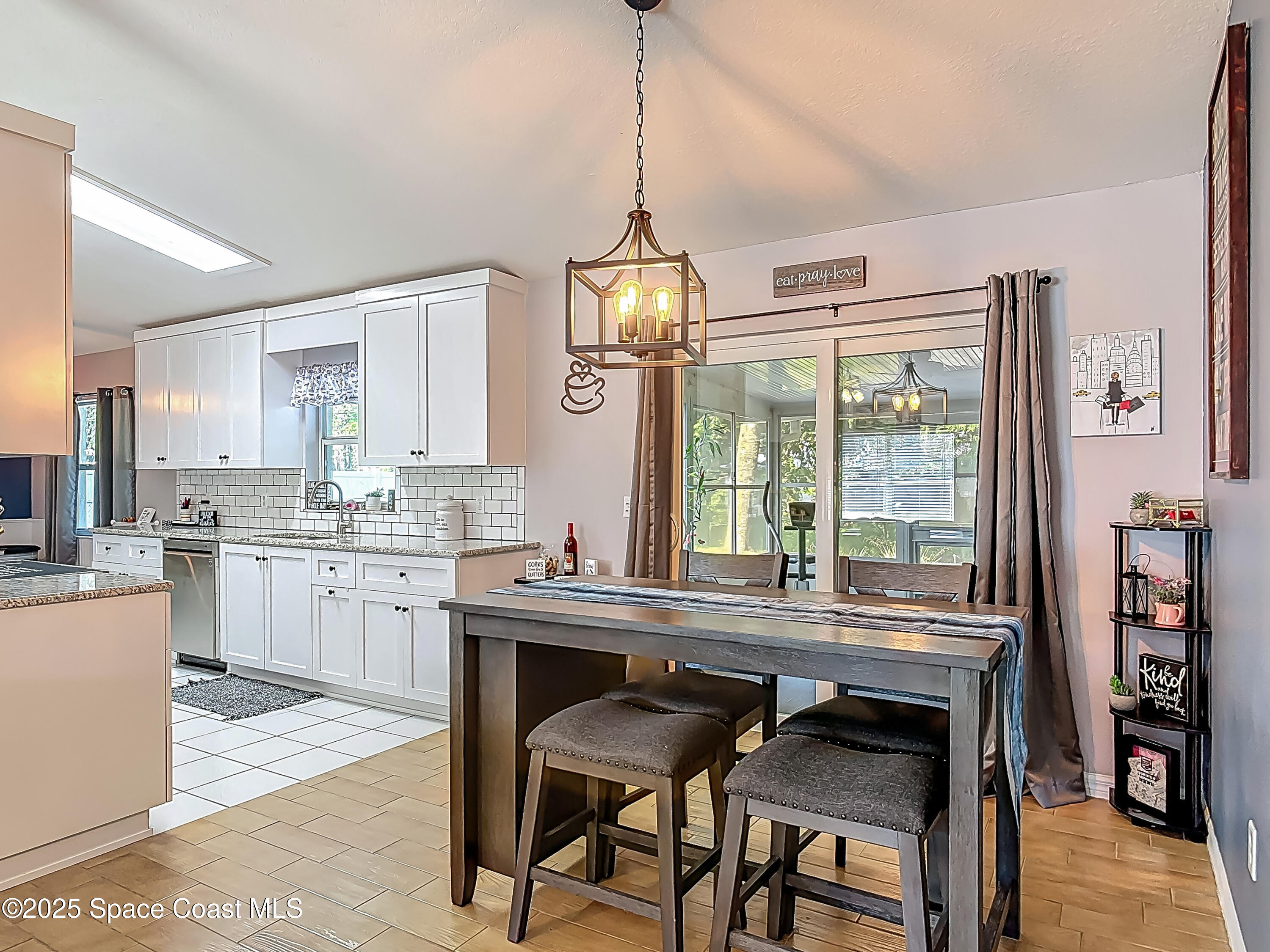 3104 Lime Tree Drive Edgewater, FL 32141 - Photo 9 of 32 a kitchen with kitchen island granite countertop a sink center island and windows