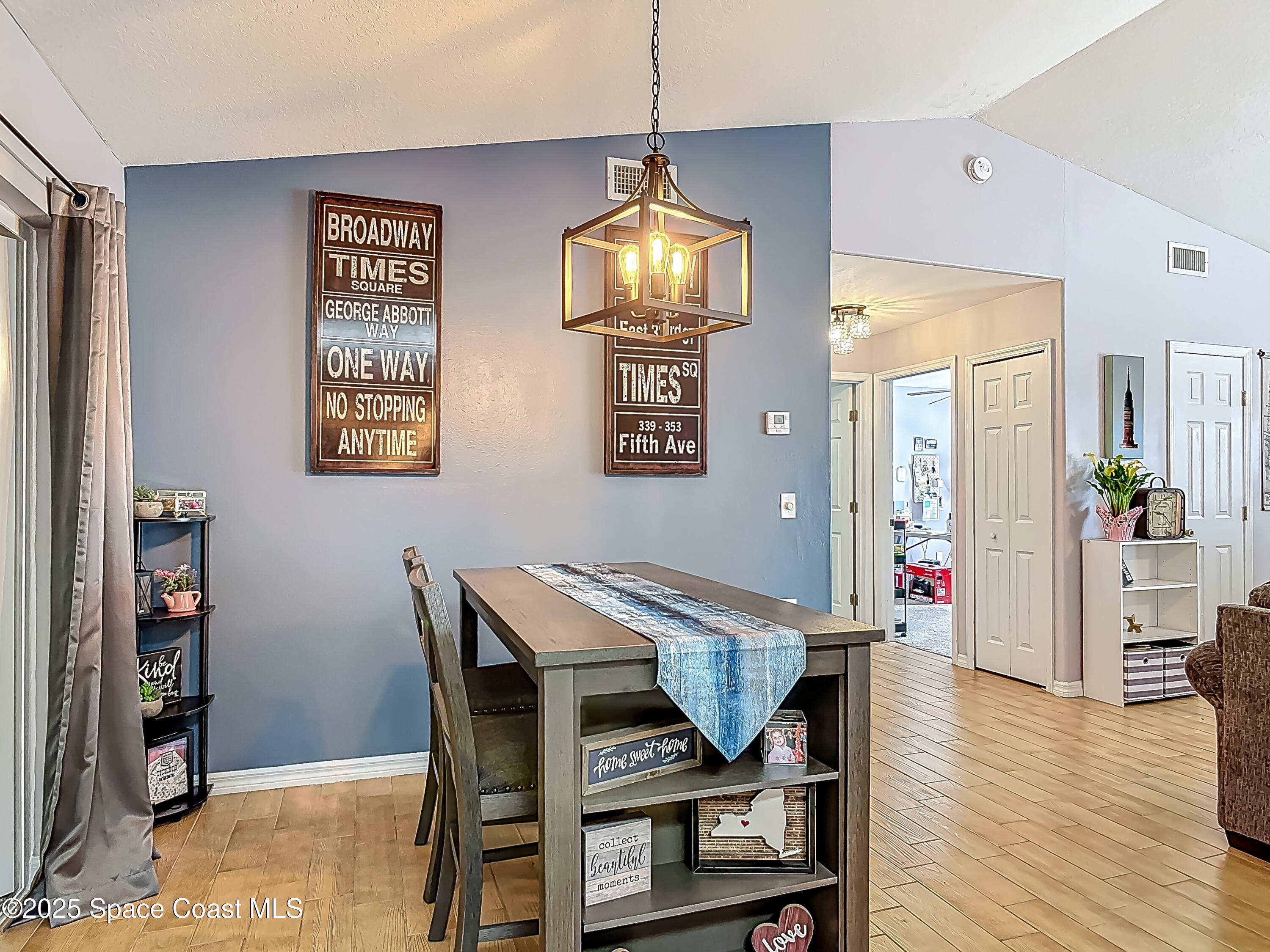 3104 Lime Tree Drive Edgewater, FL 32141 - Photo 10 of 32 a view of a dining room with furniture and wooden floor