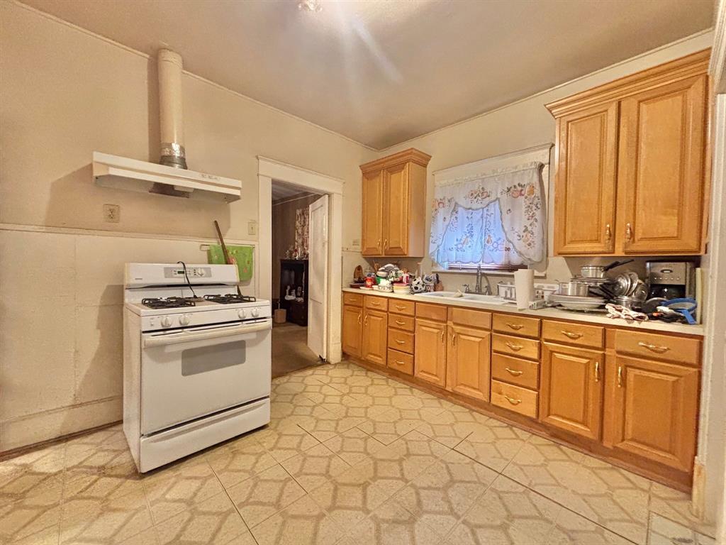 619 Delaware Street Dallas, TX 75208 - Photo 7 of 13 a kitchen with a stove top oven sink and cabinets