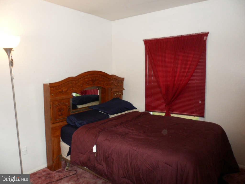 84 Ridgelawn Road, Unit B Reisterstown, MD 21136 - Photo 13 of 17 a bedroom with a bed and a closet