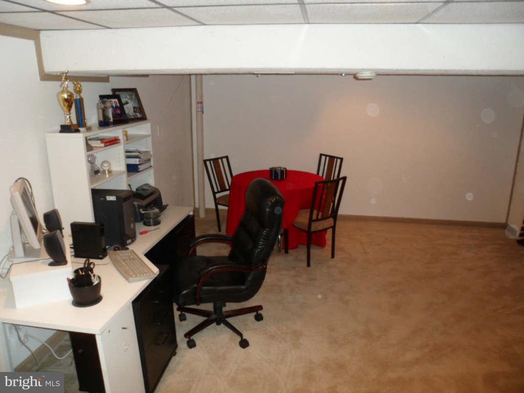 84 Ridgelawn Road, Unit B Reisterstown, MD 21136 - Photo 16 of 17 a view of a workspace with furniture and wooden floor