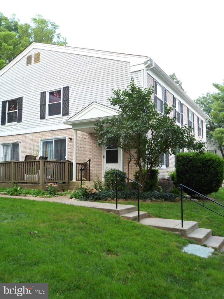 84 Ridgelawn Road, Unit B Reisterstown, MD 21136 - Photo 17 of 17 a front view of a house with a yard and green space