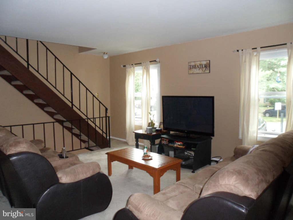 84 Ridgelawn Road, Unit B Reisterstown, MD 21136 - Photo 4 of 17 a living room with furniture and a flat screen tv