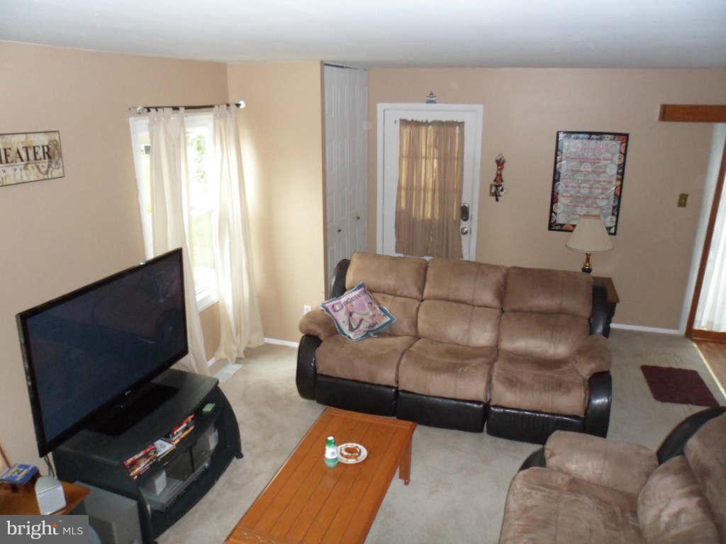 84 Ridgelawn Road, Unit B Reisterstown, MD 21136 - Photo 5 of 17 a living room with furniture and a flat screen tv