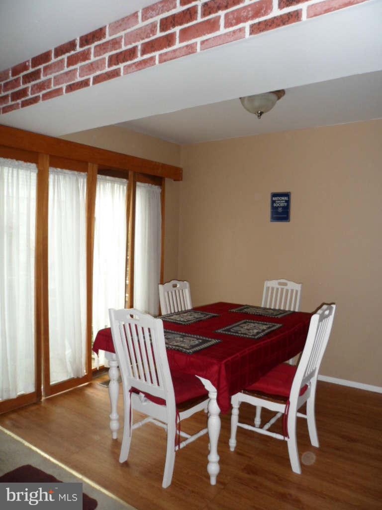 84 Ridgelawn Road, Unit B Reisterstown, MD 21136 - Photo 6 of 17 a view of a dining room with furniture and wooden floor