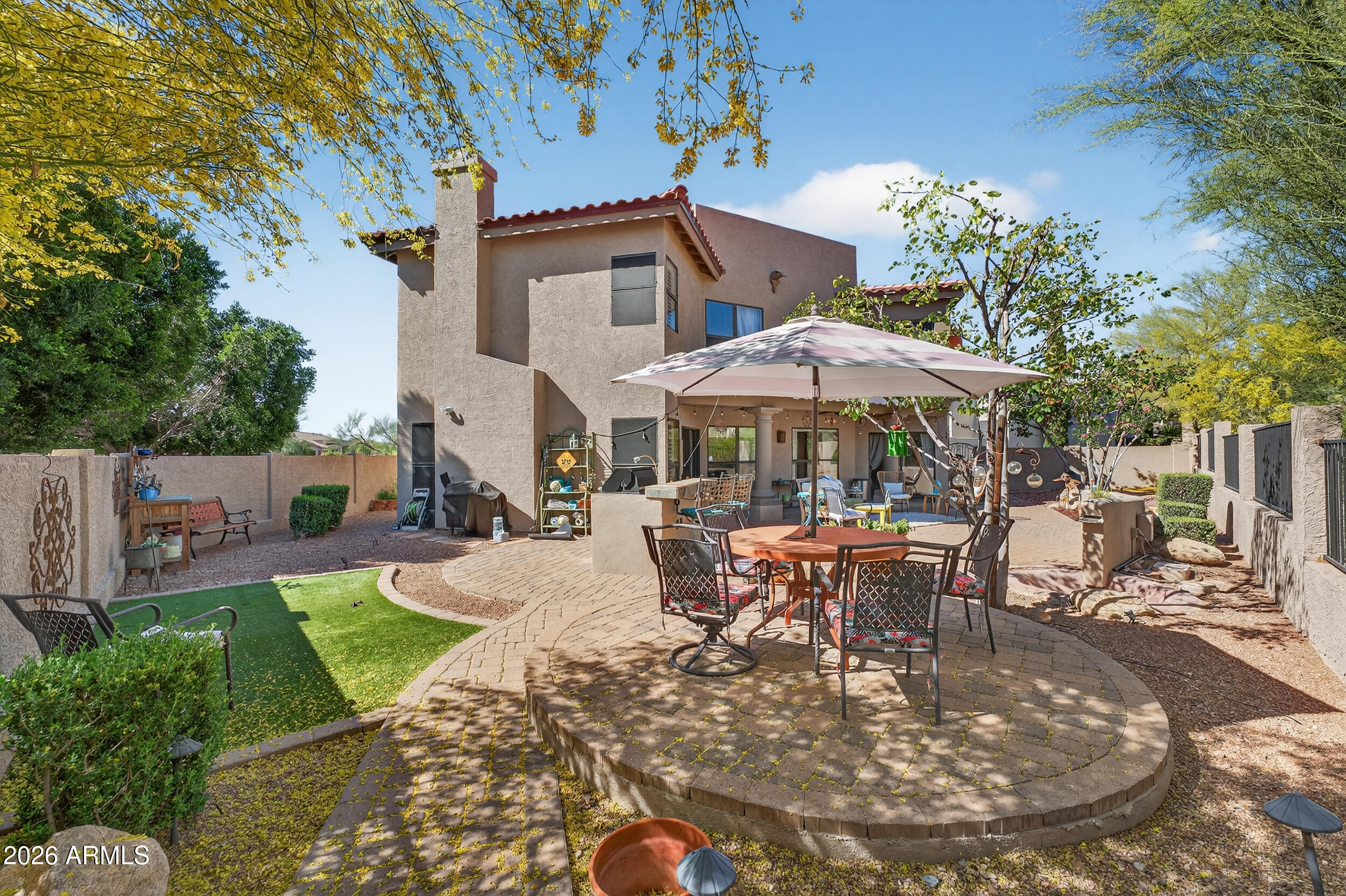 1539 East Winged Foot Road Phoenix, AZ 85022 - Photo 59 of 64 a view of a patio with table and chairs under an umbrella