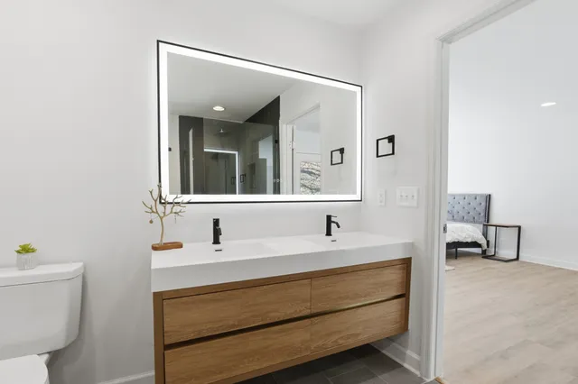 a view of a livingroom with wooden floor and a ceiling fan