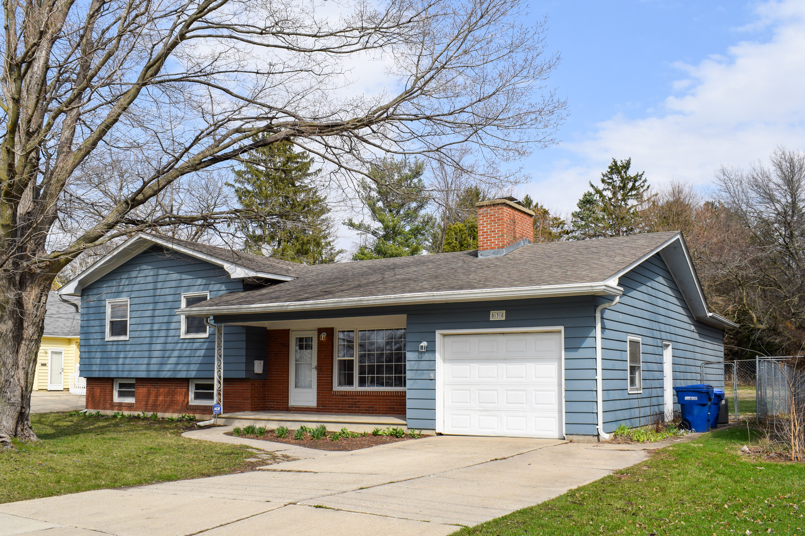 538 Russell Road DeKalb, IL 60115 - Photo 1 of 35 a front view of a house with a yard and potted plants