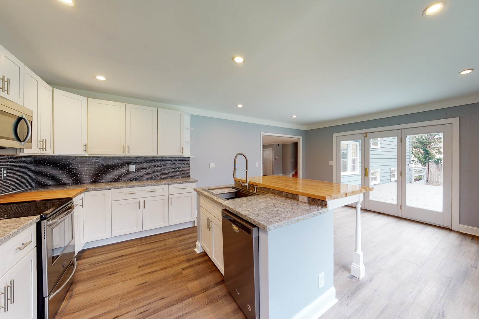 538 Russell Road DeKalb, IL 60115 - Photo 2 of 35 a kitchen that has a sink a stove and wooden floor